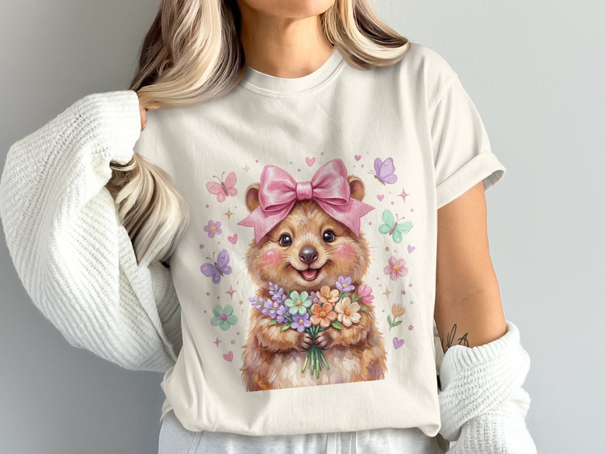 Cartoon hamster in pink bow and dress holding a bouquet of flowers.