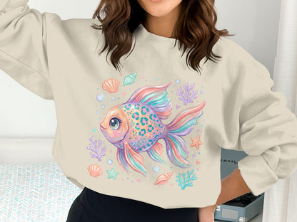 Pastel fish illustration with seashells and starfish on a cream sweatshirt.