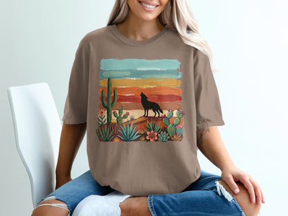 Brown t-shirt with desert landscape and howling wolf graphic.
