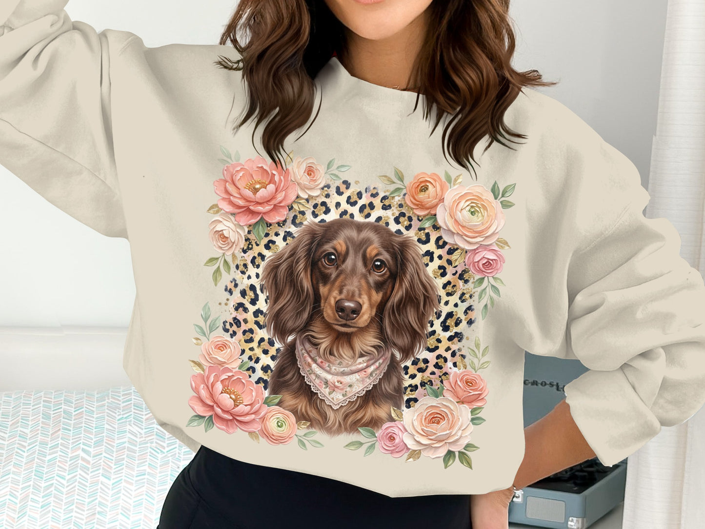 Crewneck sweatshirt with dachshund and floral wreath graphic.