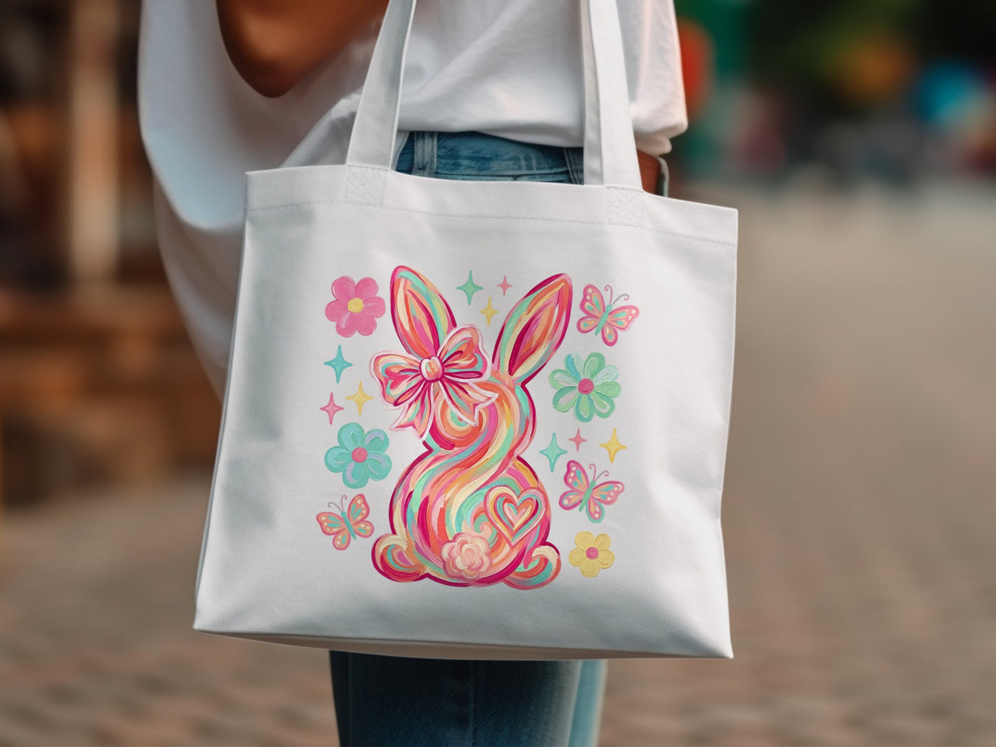 White tote bag with colorful Easter bunny and flowers design.