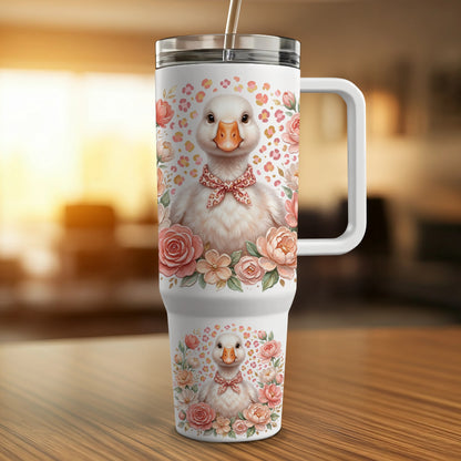White tumbler with a cute duckling wearing a pink bow and surrounded by flowers.