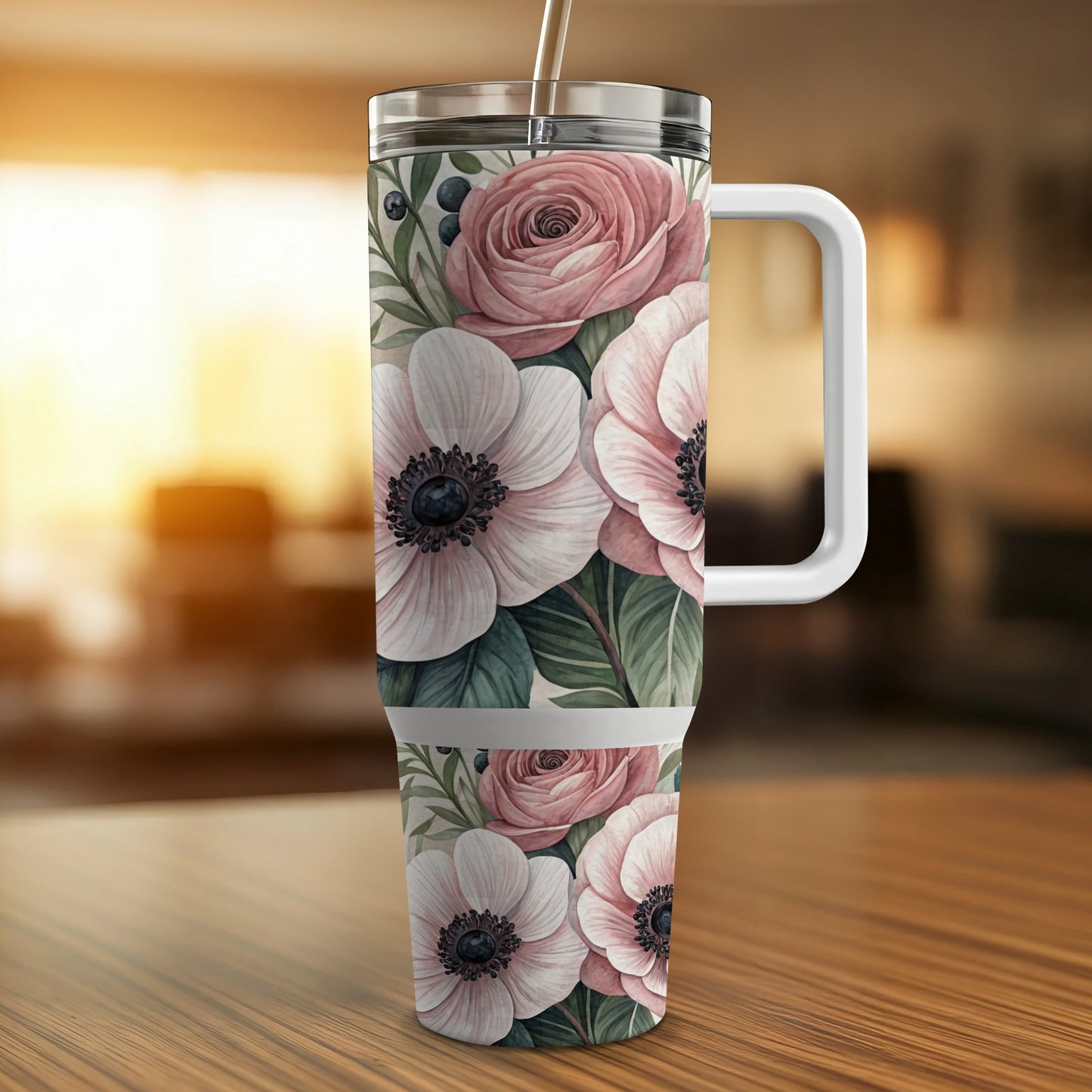 White floral pattern tumbler with handle and straw on wooden table.
