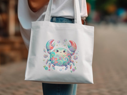 White canvas tote bag featuring a colorful, whimsical crab illustration with floral and shell accents.