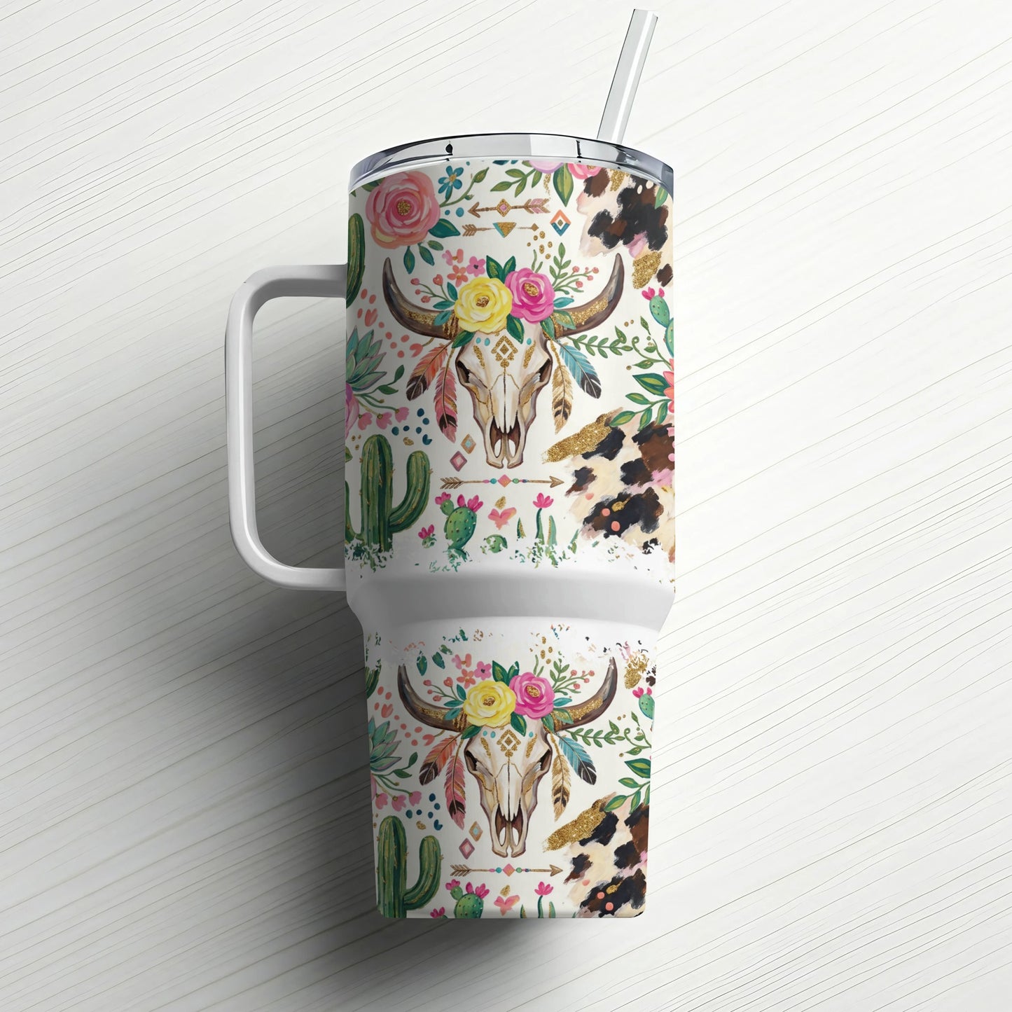 Tumbler with cow skull, floral, and cactus pattern.