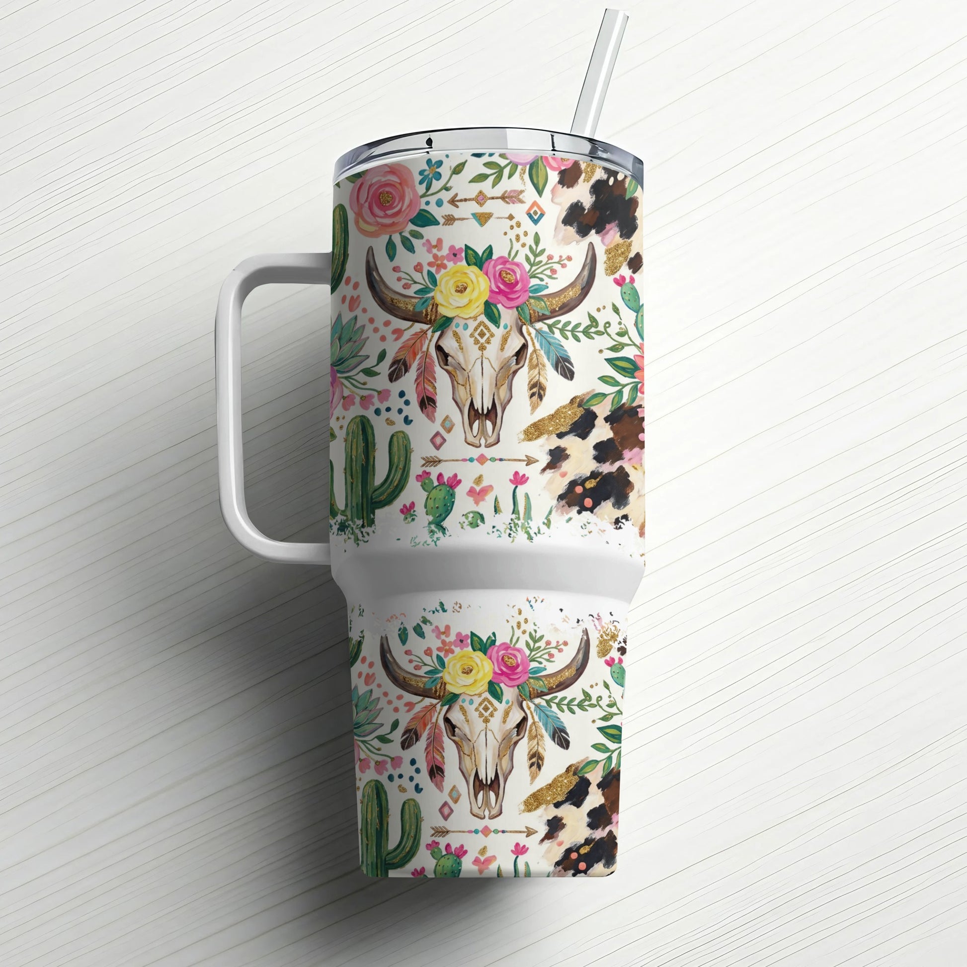 Tumbler with cow skull, floral, and cactus pattern.