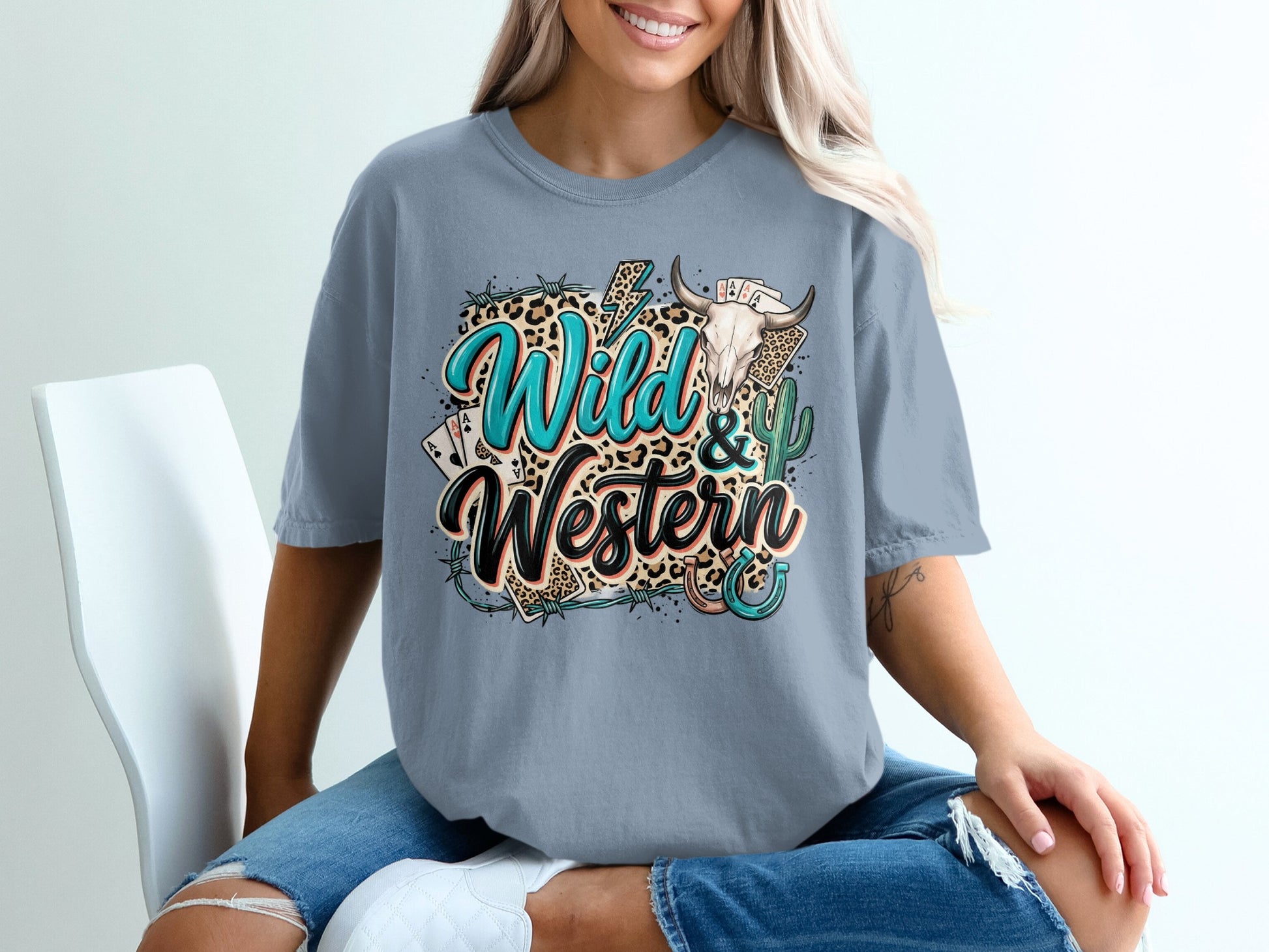 "Wild & Western" graphic tee with skull, cards, and cactus elements.