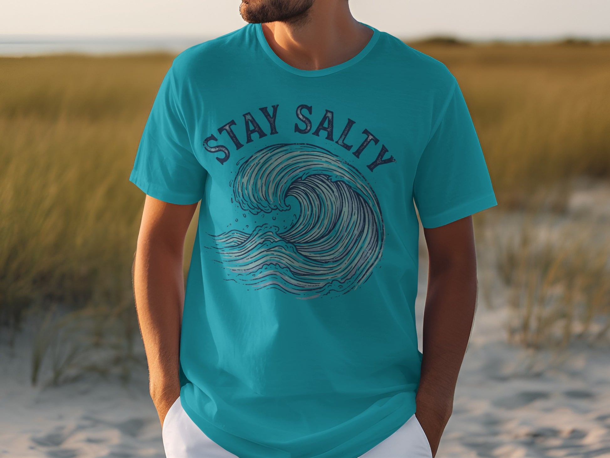 Teal t-shirt with "Stay Salty" text and a stylized wave graphic.