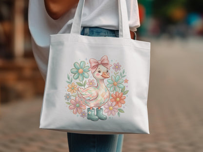 White tote bag with a cartoon duckling wearing boots and surrounded by pastel flowers.