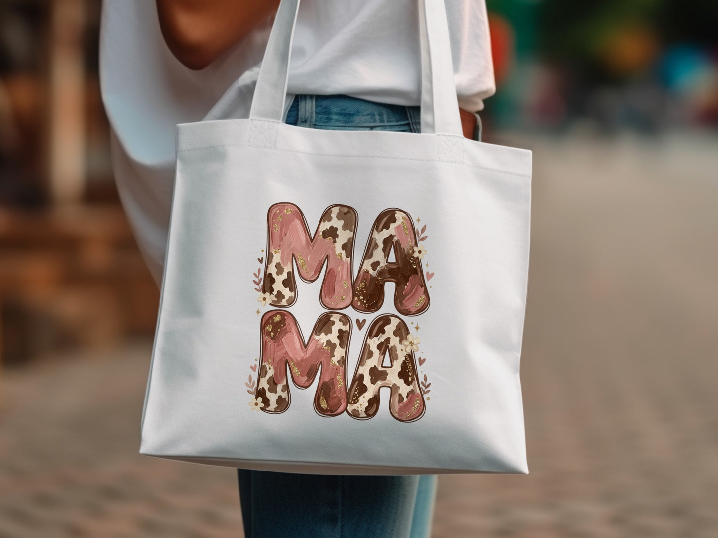 White canvas tote bag with "MAMA" in cow print and floral accents.