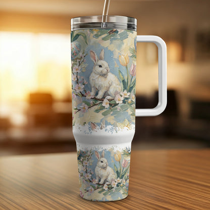 White bunny and tulips design on a tumbler with a handle.