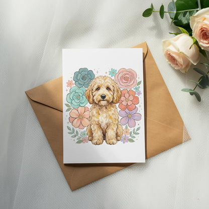 Card featuring a goldendoodle puppy surrounded by colorful flowers on an envelope.