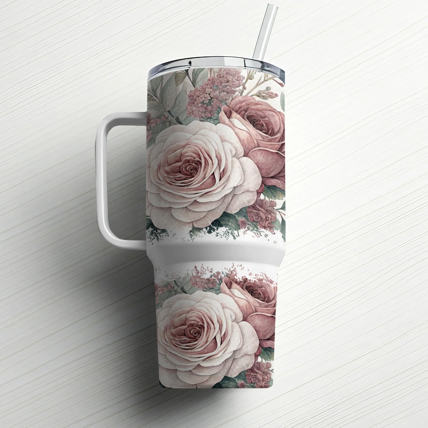 White tumbler with a floral design of pink and white roses and green leaves.