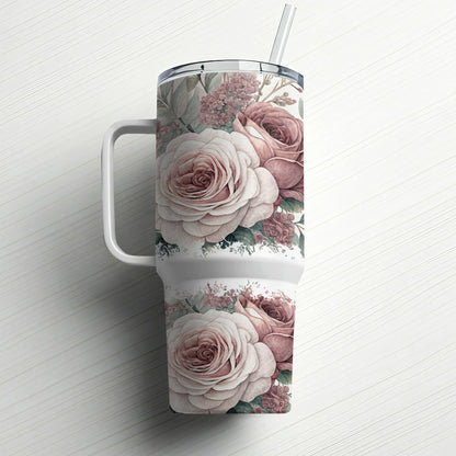White tumbler with a floral design of pink and white roses and green leaves.