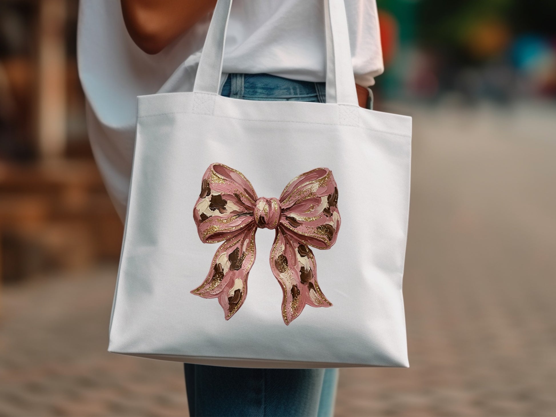 White canvas tote bag with a pink sequined bow design.