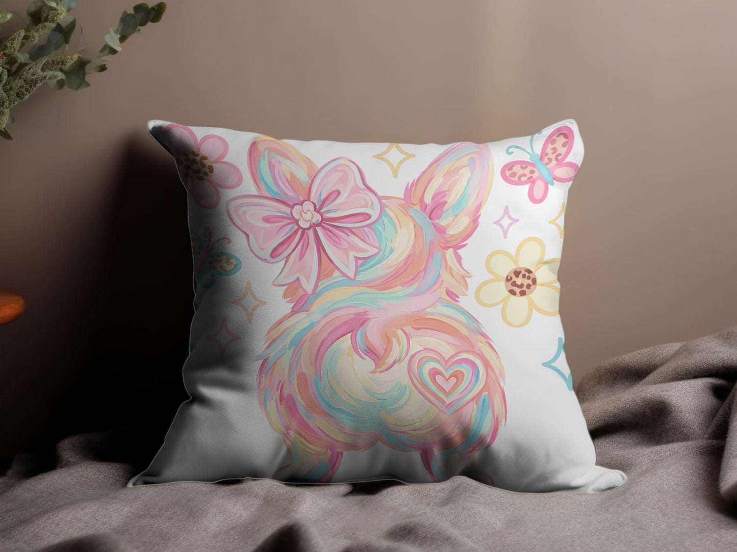 Cushion with pastel rainbow corgi, butterflies, and flowers.