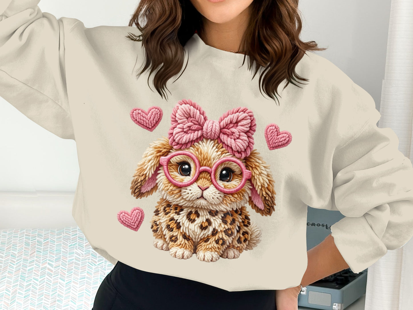 Crewneck sweatshirt with a leopard print bunny graphic wearing pink glasses and a bow.