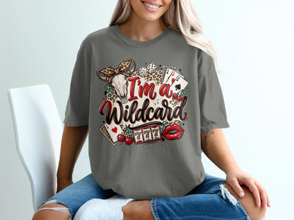 Graphic tee with I'm a Wildcard text, skull, cards, cherries, and slot machine.