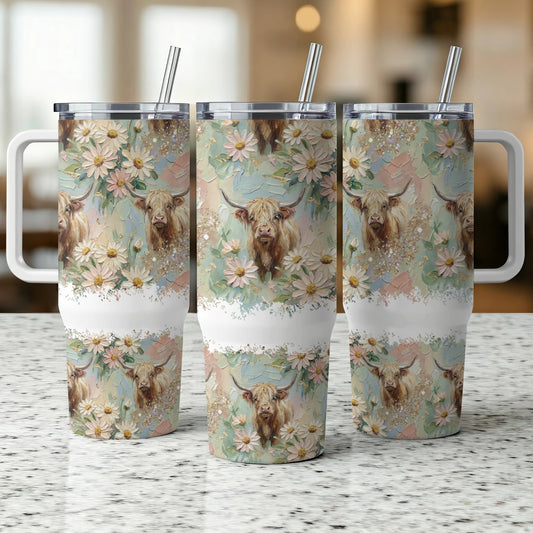 Three Highland cows with floral patterns on tumblers.
