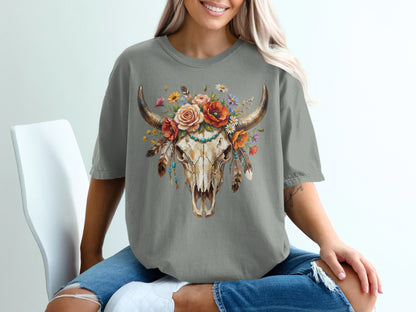 Skull with floral headdress, feathers, and turquoise details on a t-shirt.