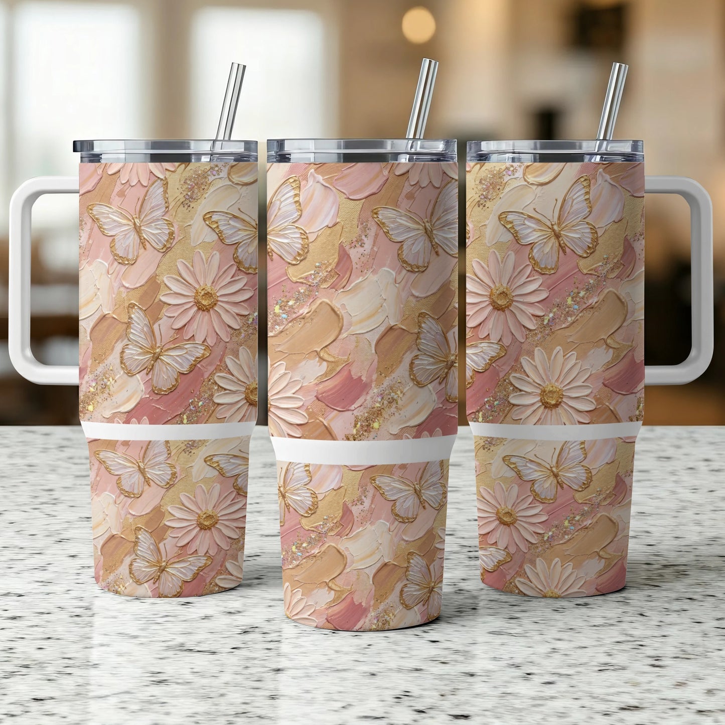 Three tall tumblers with butterflies and floral designs, with handles and straws.
