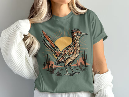 Roadrunner graphic on a dusty green t-shirt with desert sunset and cactus.