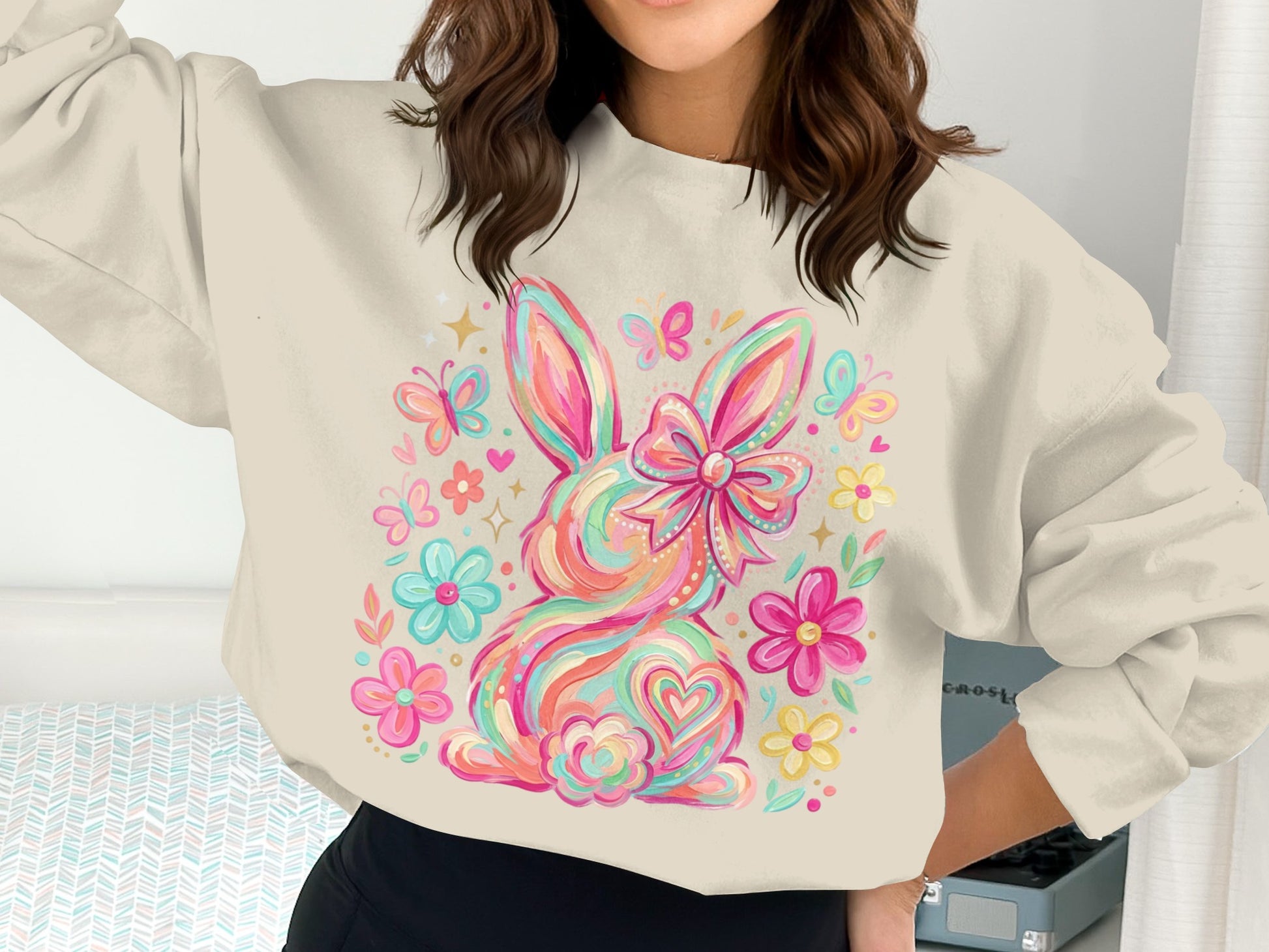 Colorful graphic sweatshirt with a bunny, bow, and flowers.