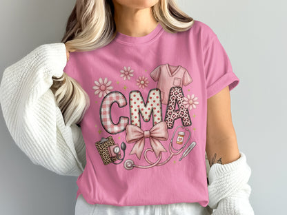 Pink t-shirt with "CMA" in patterned letters and medical icons.