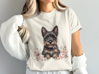 Cream t-shirt with graphic of a scruffy terrier dog surrounded by pink flowers.