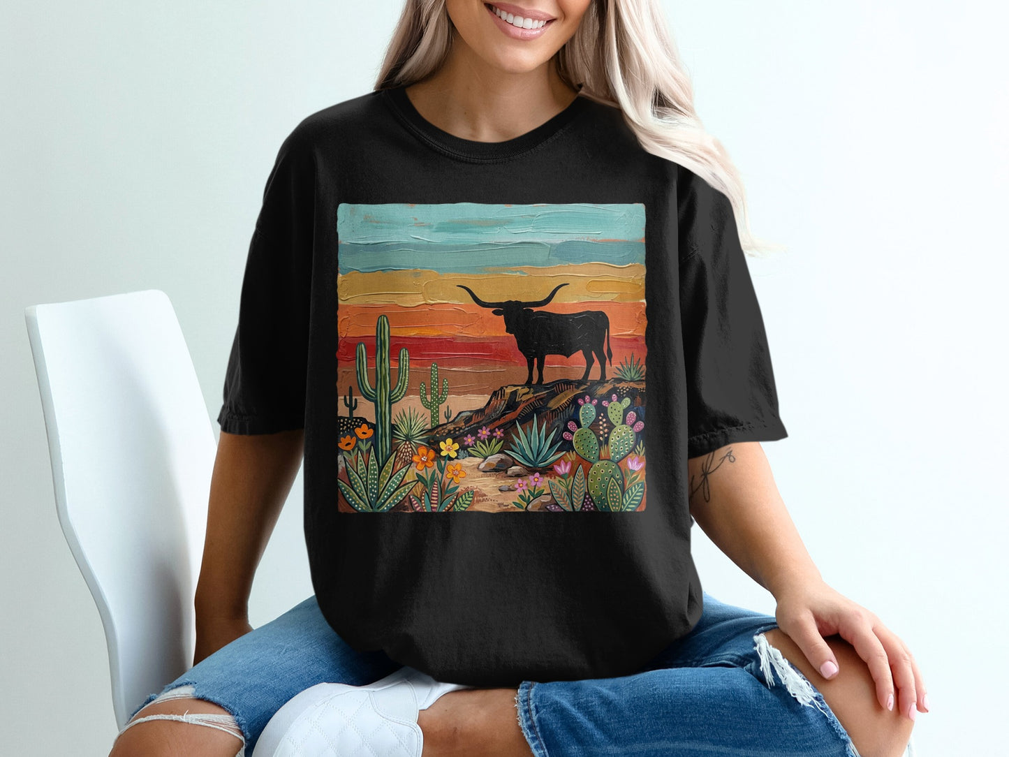 Black t-shirt with colorful desert landscape featuring a longhorn bull.