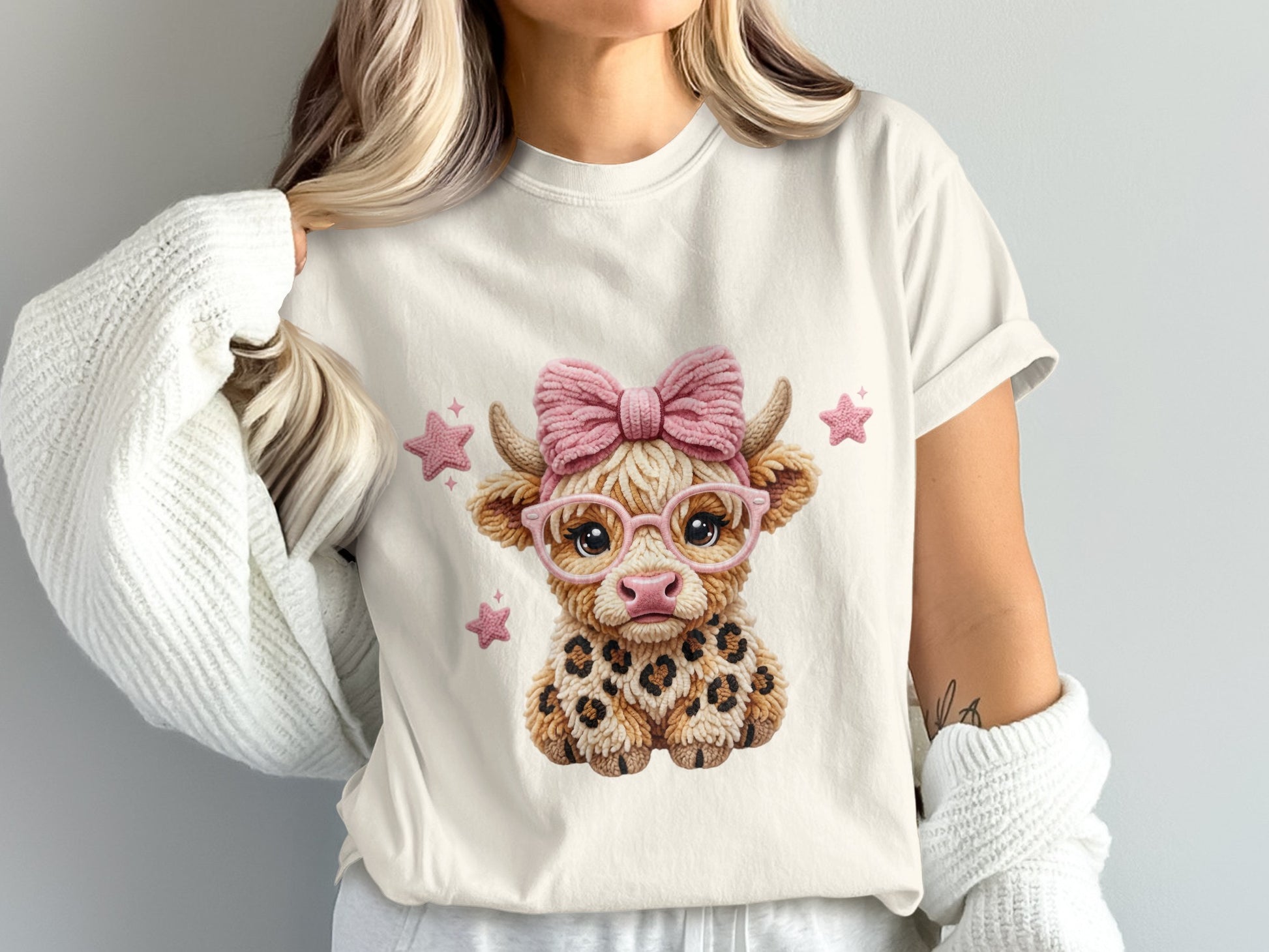 Cute cow graphic with pink glasses and bow on a t-shirt.