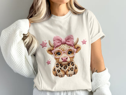 Cute cow graphic with pink glasses and bow on a t-shirt.