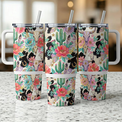 Three travel tumblers with a cow skull, cactus, and floral pattern.