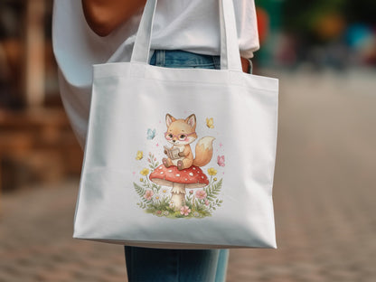 White tote bag with watercolor illustration of a fox reading on a mushroom.