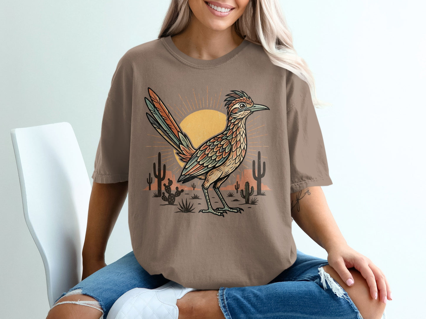 T-shirt with desert scene featuring a roadrunner, sun, and cacti.