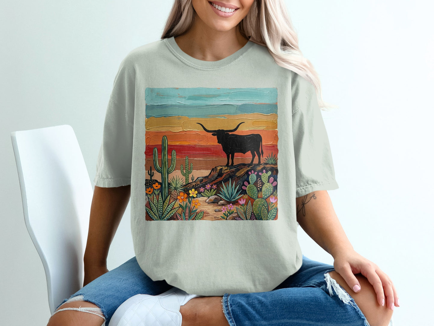 T-shirt with a painted desert landscape featuring a longhorn bull.