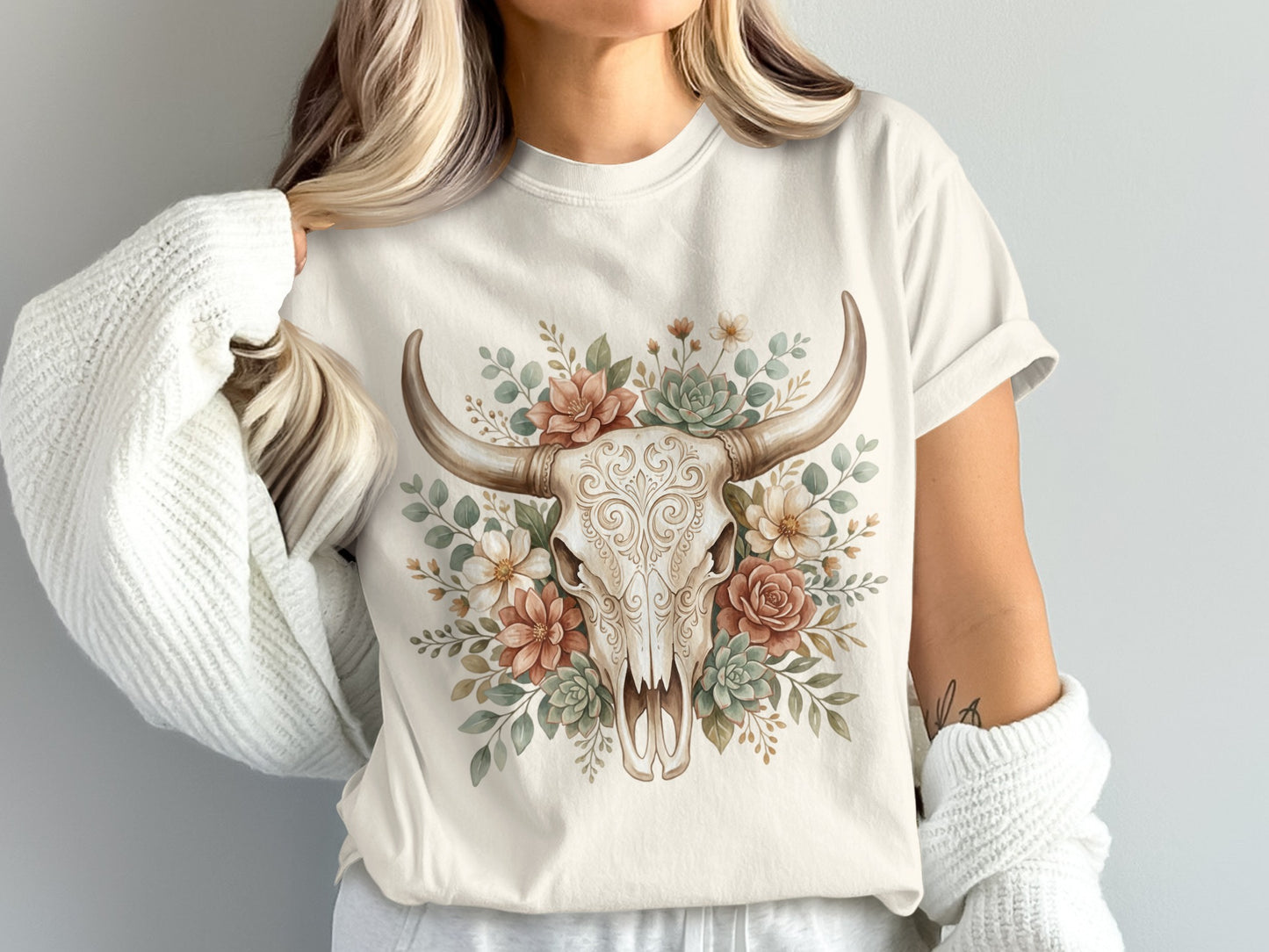 Cream t-shirt with a skull surrounded by flowers and succulents.