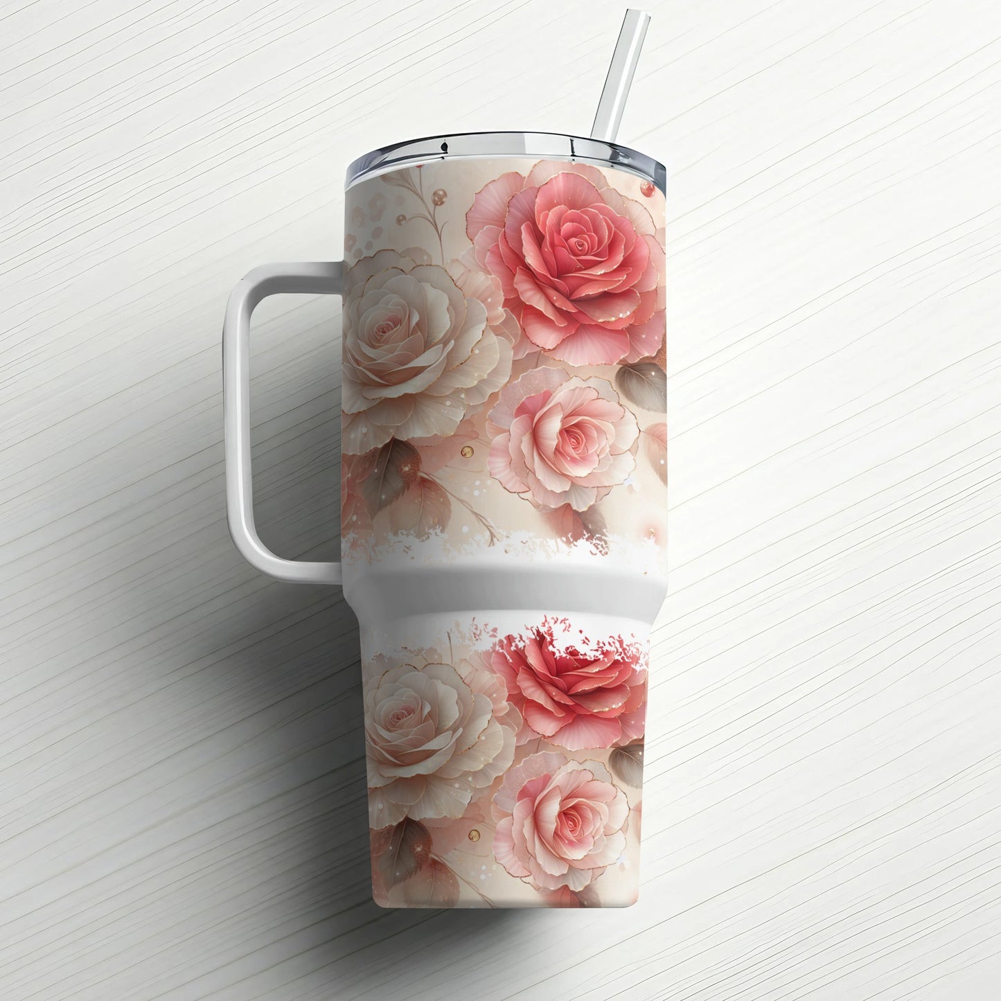White tumbler with pink and red roses and a straw on a white surface.