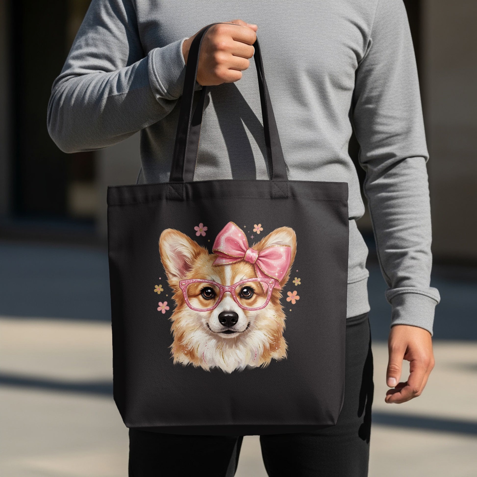 Black tote bag with a cartoon corgi wearing glasses and a pink bow.