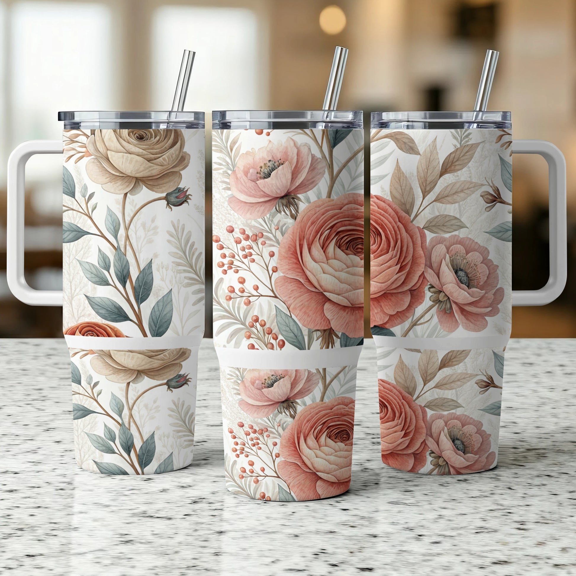 Three tumblers with a floral and leaf pattern on a speckled countertop.