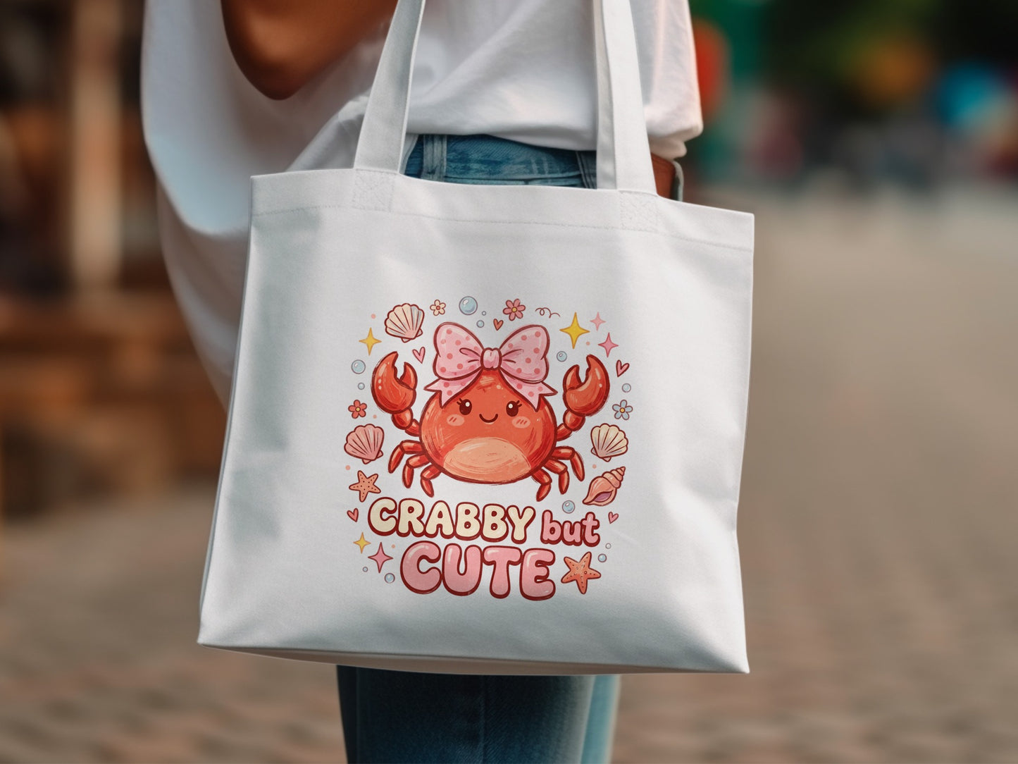 White tote bag with cute crab graphic and "Crabby but cute" text.