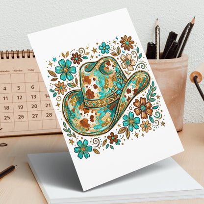 Cowboy hat adorned with floral and glittery accents on a blank card.