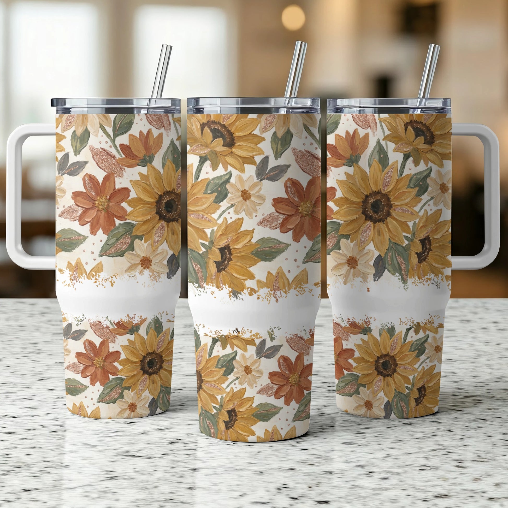 Three tumblers with sunflowers and fall floral pattern, each with a handle and straw.