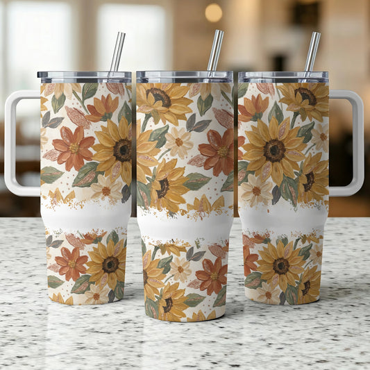 Three tumblers with sunflowers and fall floral pattern, each with a handle and straw.