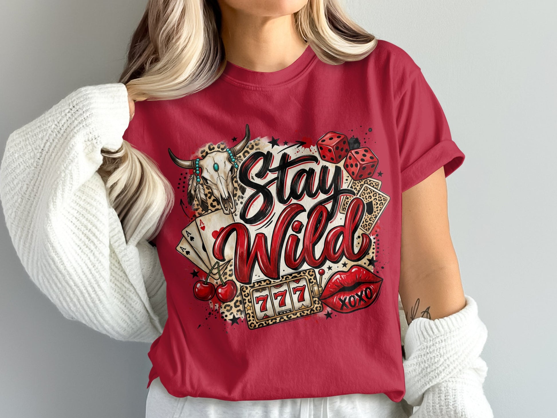 Red t-shirt with "Stay Wild" text, bull skull, dice, cards, and cherries graphic.
