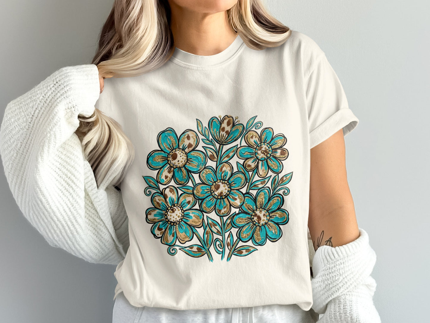 Cream t-shirt with a blue and gold floral design.